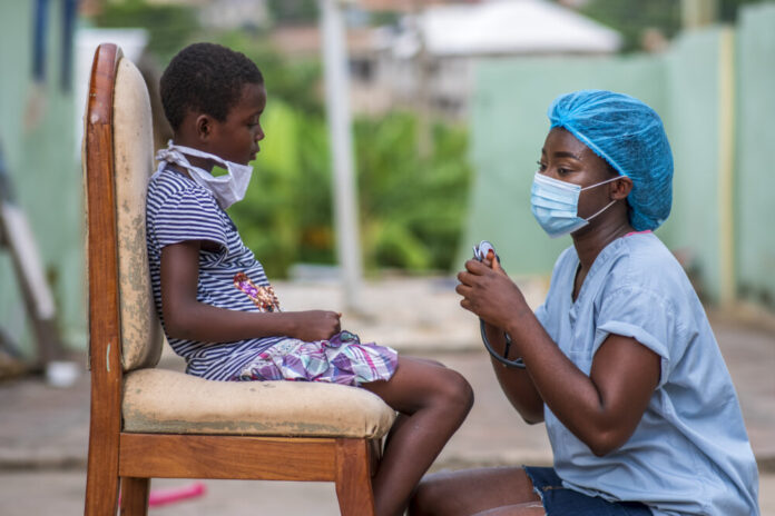 African-American boy getting a checkup by a doctor