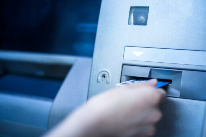 Woman using cash machine-ATM,close up view