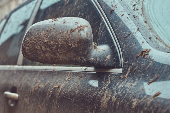 Close-up image of a dirty car after a trip around the countryside