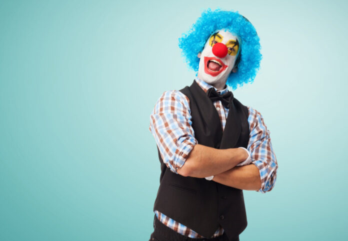 portrait of a clown smiling over white background