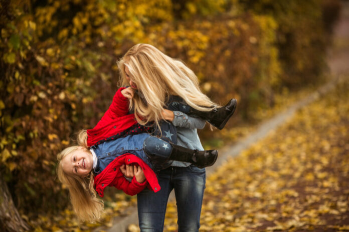 Mother with daughter in autumn park