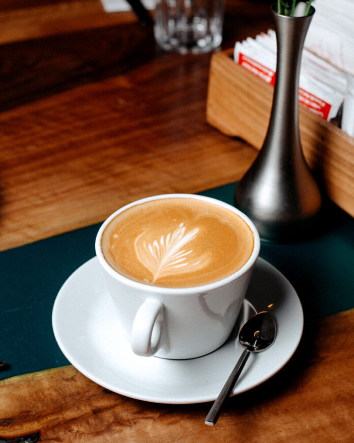 side view of a cup of coffee latte on a wooden table