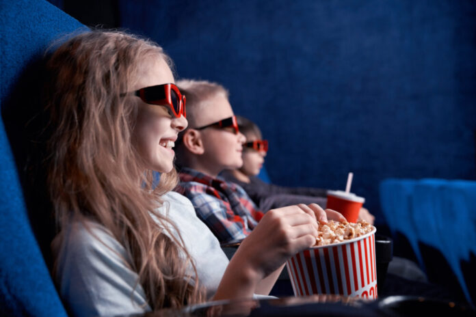 Children wearing 3d glasses watching funny film in cinema