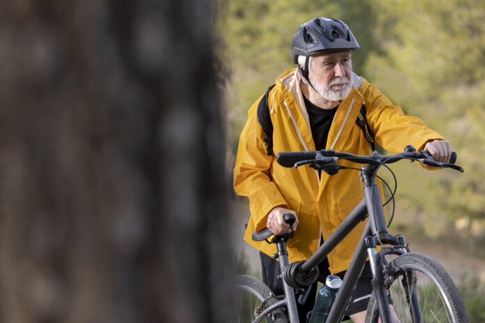 portrait-senior-man-with-bike-mountain
