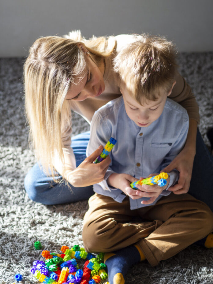 adorable-young-boy-playing-with-toys