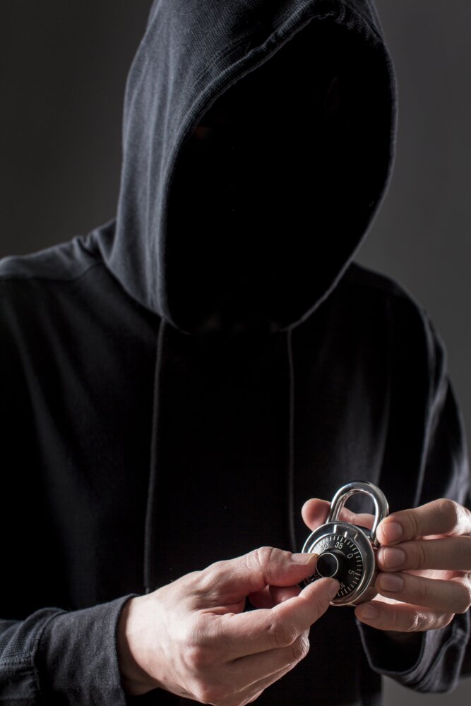 front-view-male-hacker-holding-lock