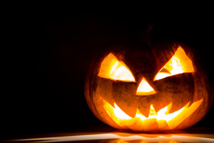 Halloween scary face pumpkin on black background